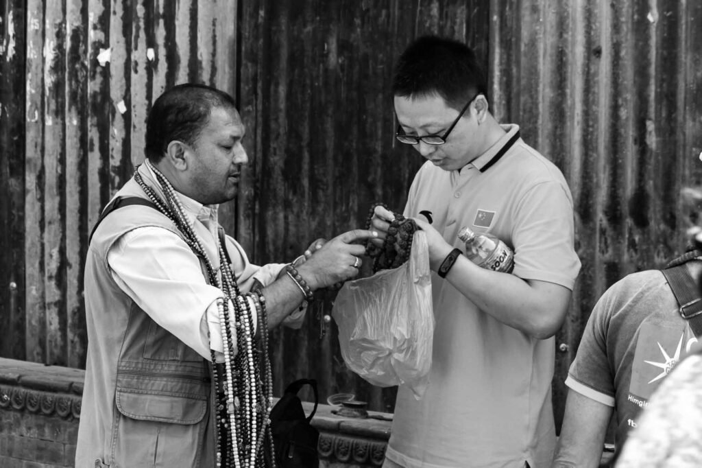 Showing souvenir to the foreigner.