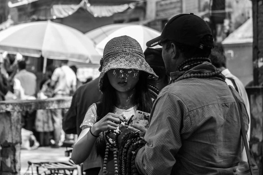 Chinese tourist watching handicrafts