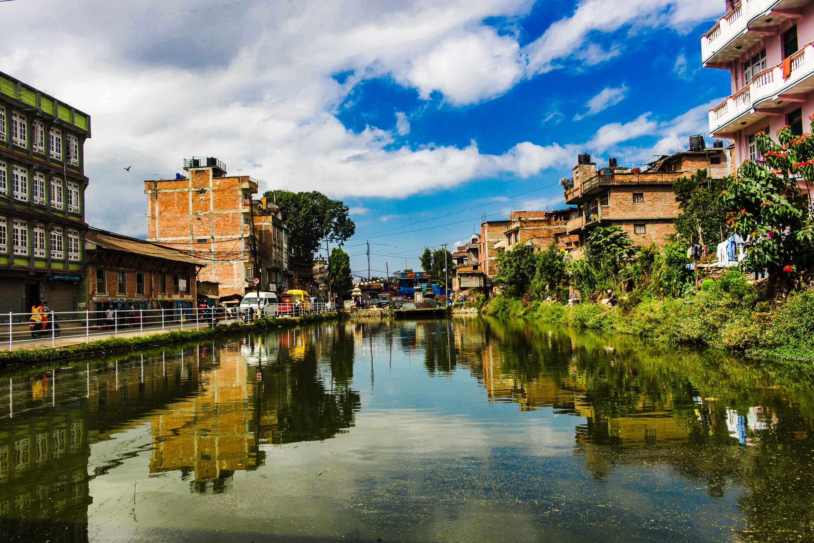 Historic Brick Buildings Reflected in a Quiet Pond in Kirtipur.