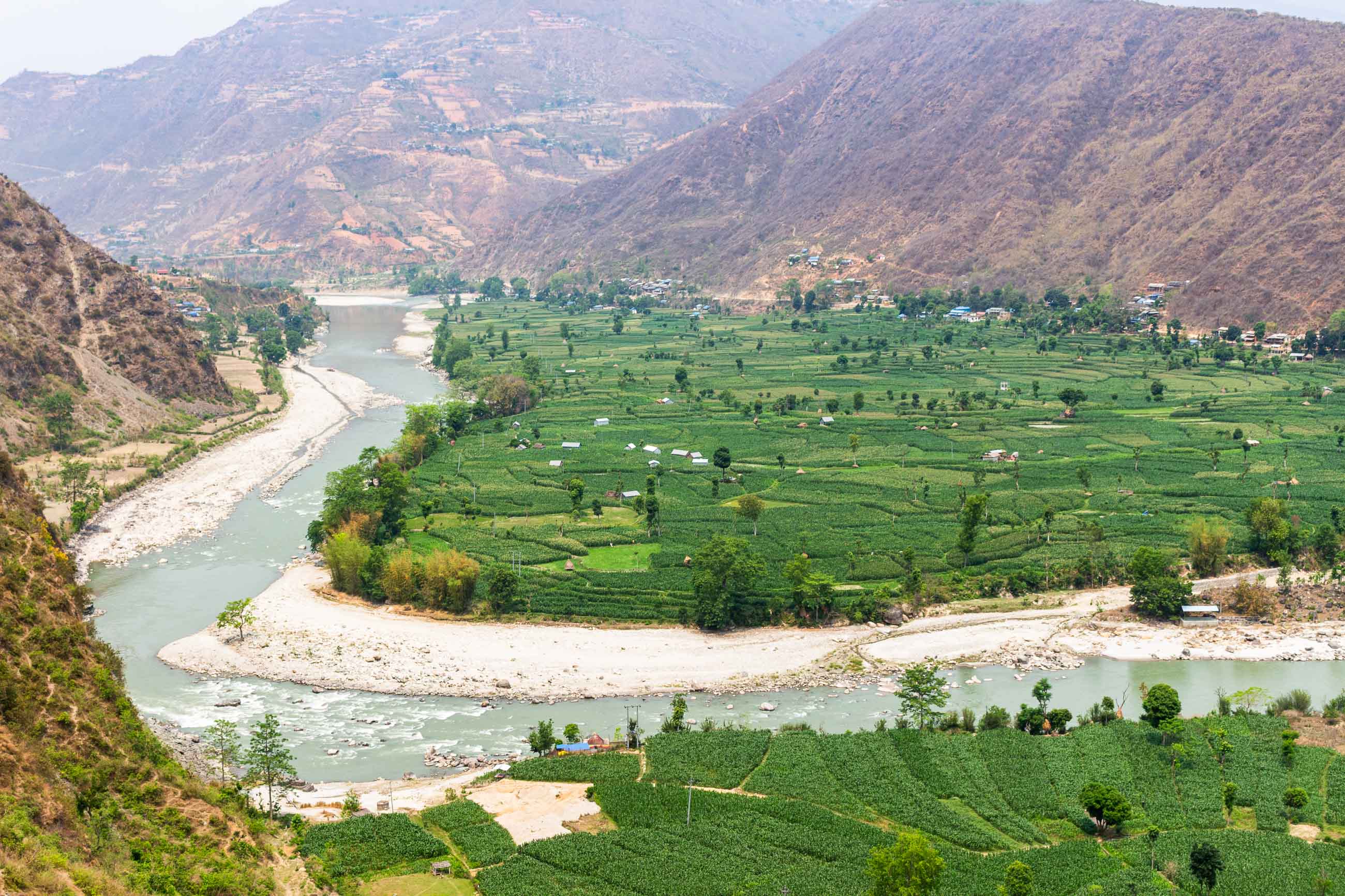 A Wide River Bending Past Agricultural Terraces in Mugitar.