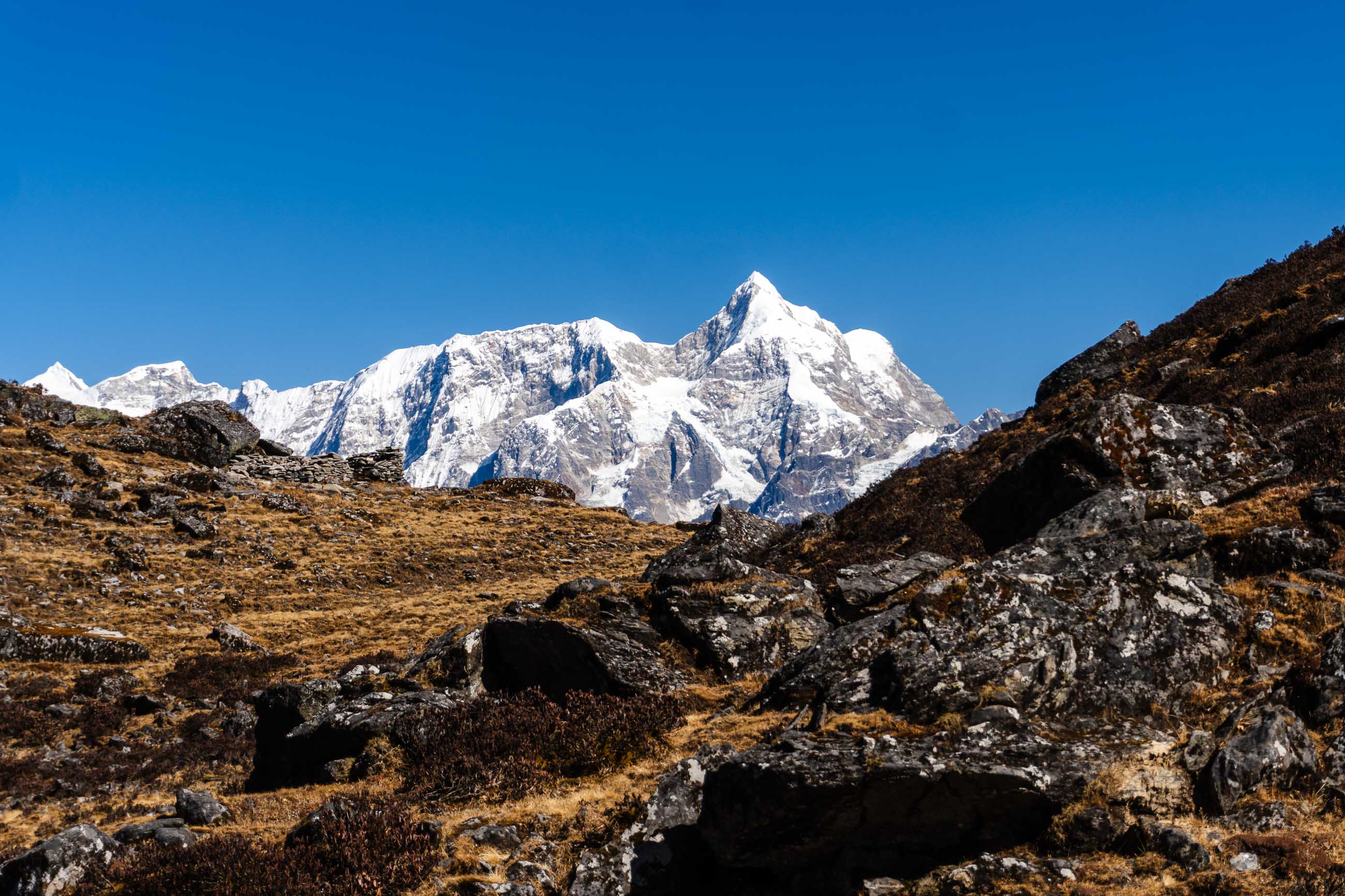 The Snow-Capped Peak of Mount Numbur Rising Beyond a Rocky Ridge.