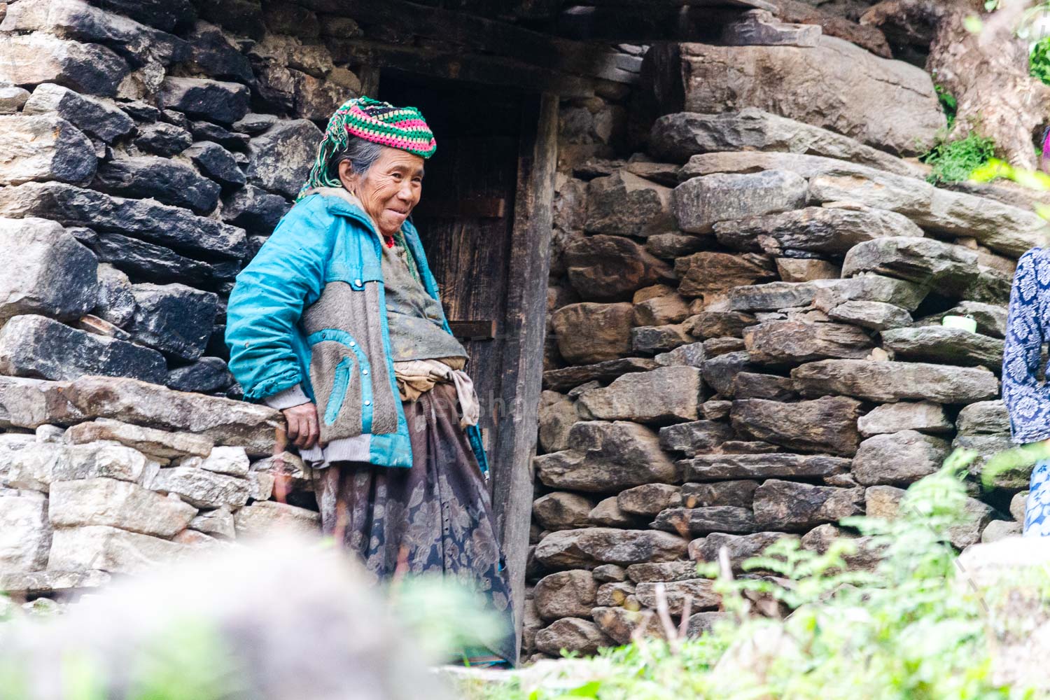 Woman at Her Stone Home