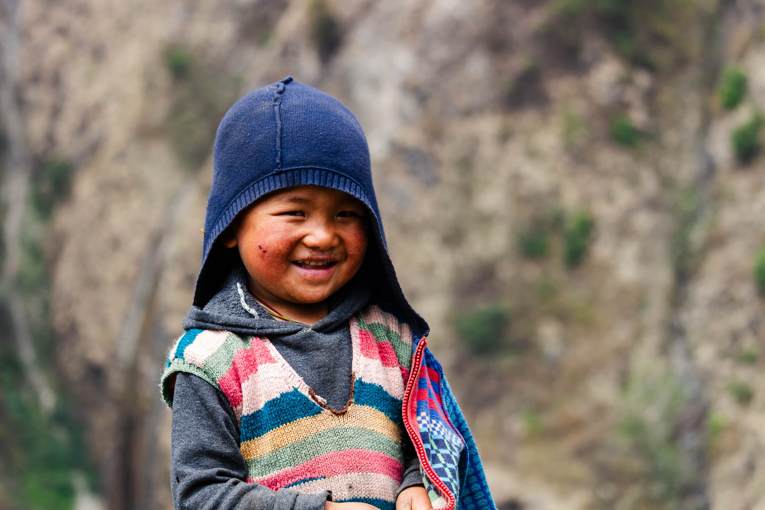 Smiling Child in Traditional Himalayan Clothing.