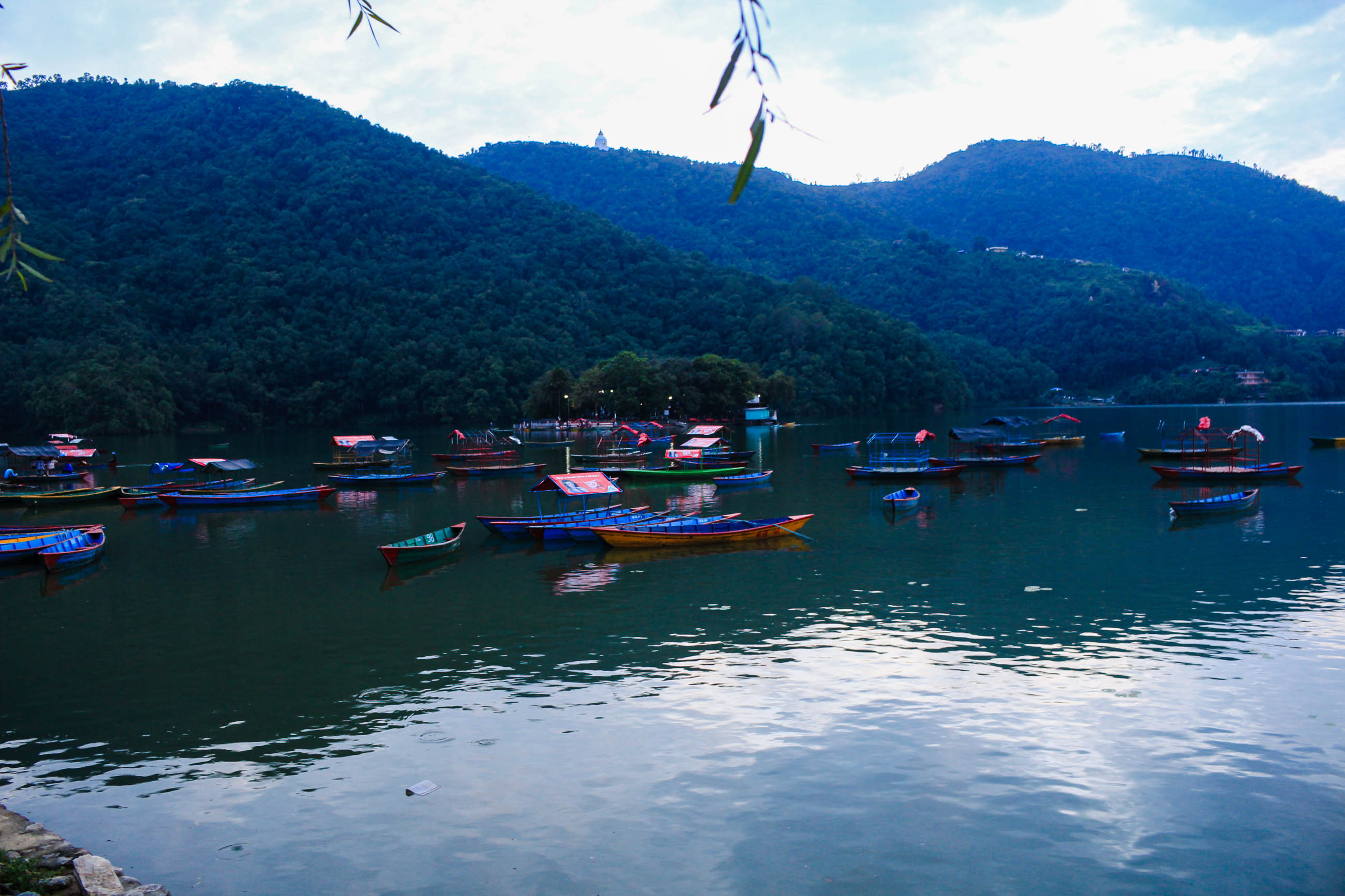 Colorful Boats Floating on Phewa Lake Near Tal Barahi Temple in Pokhara.